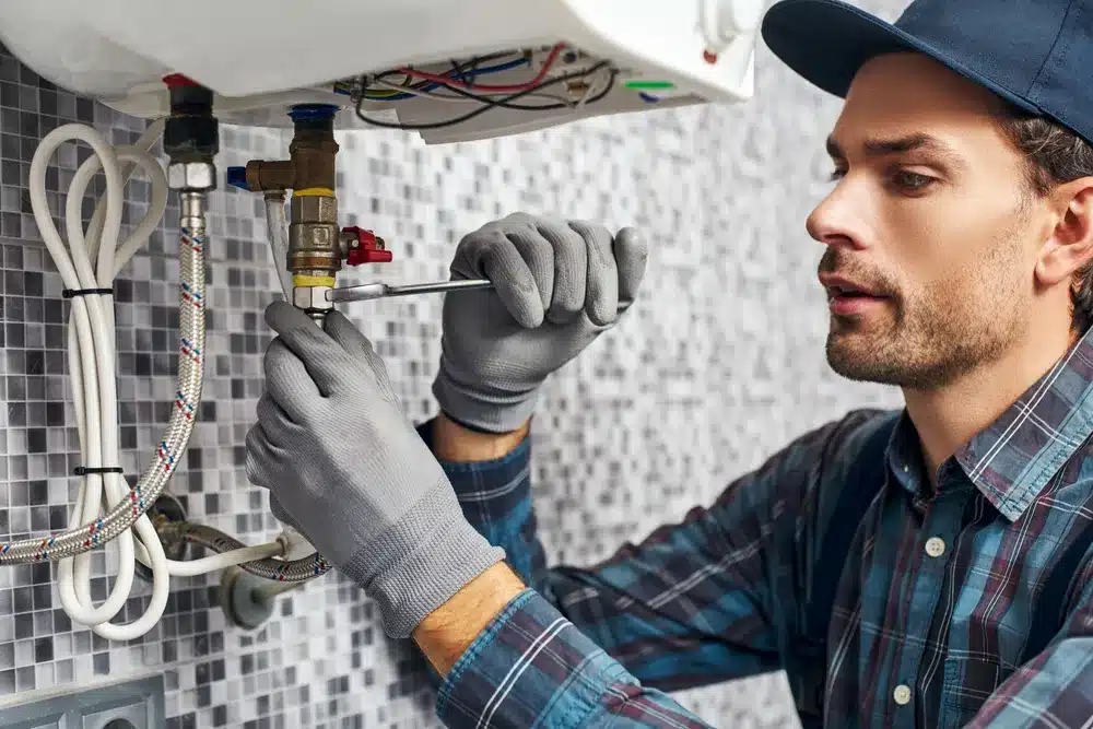 Technician fixing water heater in Houston, TX.