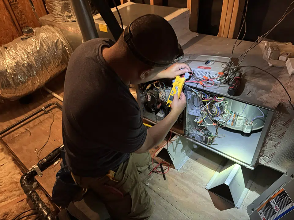 tech performing furnace maintenance in houston, tx