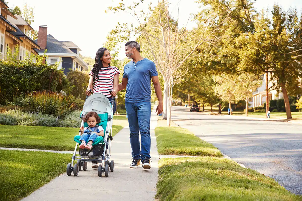 Happy family walking down the street in Houston, TX.