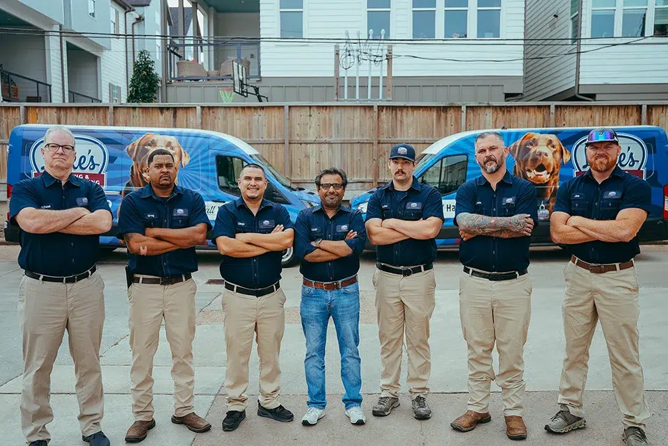 Luke's team in front of service vans