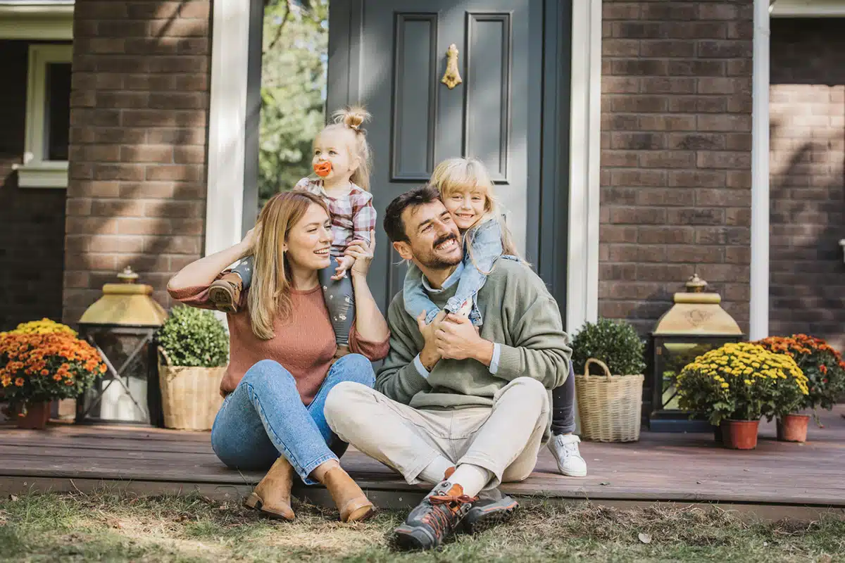 Happy Family sitting on porch in Houston, TX.