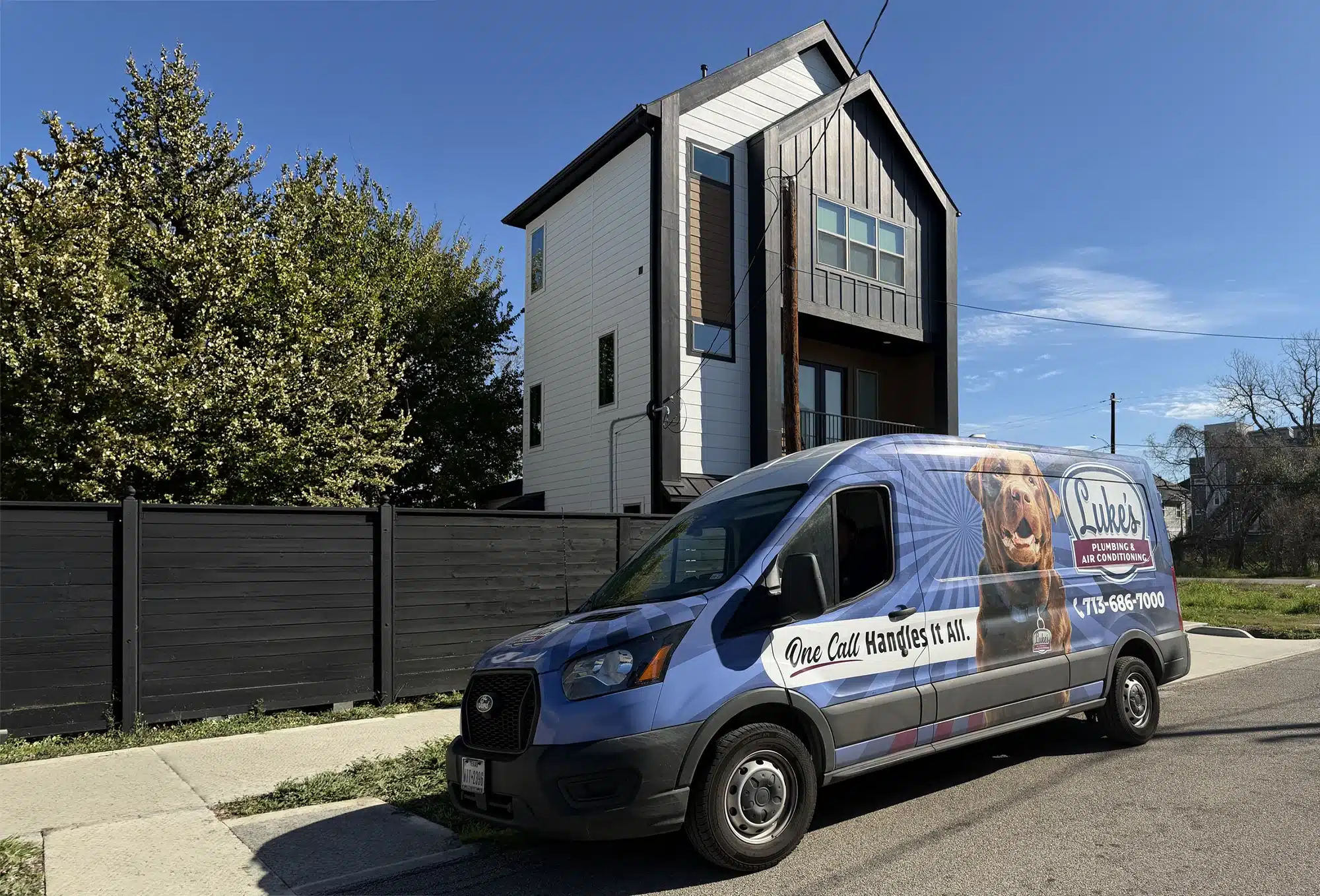 Luke's Plumbing & Air Conditioning service van parked outside a modern Houston home on a sunny day
